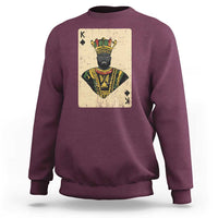 Maroon crewneck sweatshirt with front playing-card king graphic and ribbed hem
