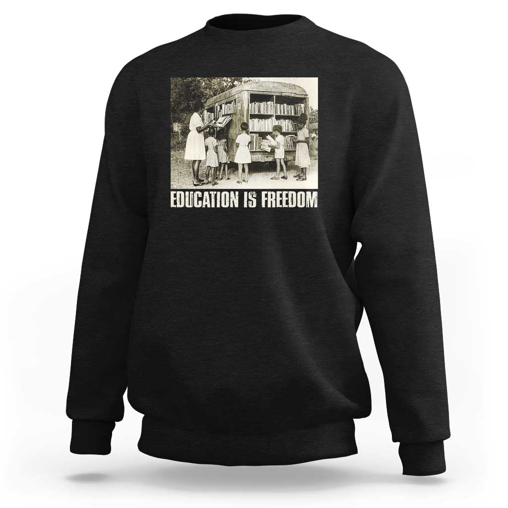 Black sweatshirt with 'EDUCATION IS FREEDOM' front graphic, crewneck long sleeves