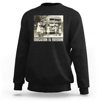Black sweatshirt with 'EDUCATION IS FREEDOM' front graphic, crewneck long sleeves