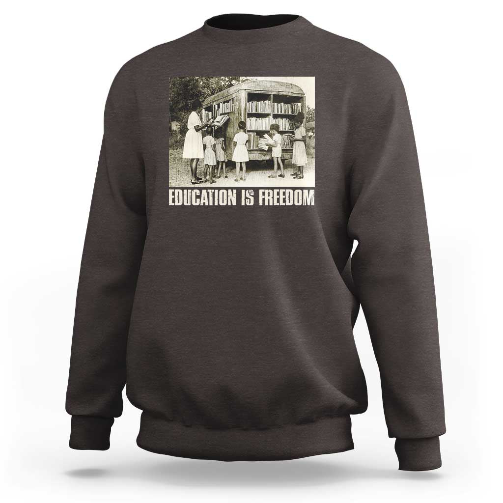 Dark chocolate sweatshirt with 'EDUCATION IS FREEDOM' front graphic, crewneck long sleeves
