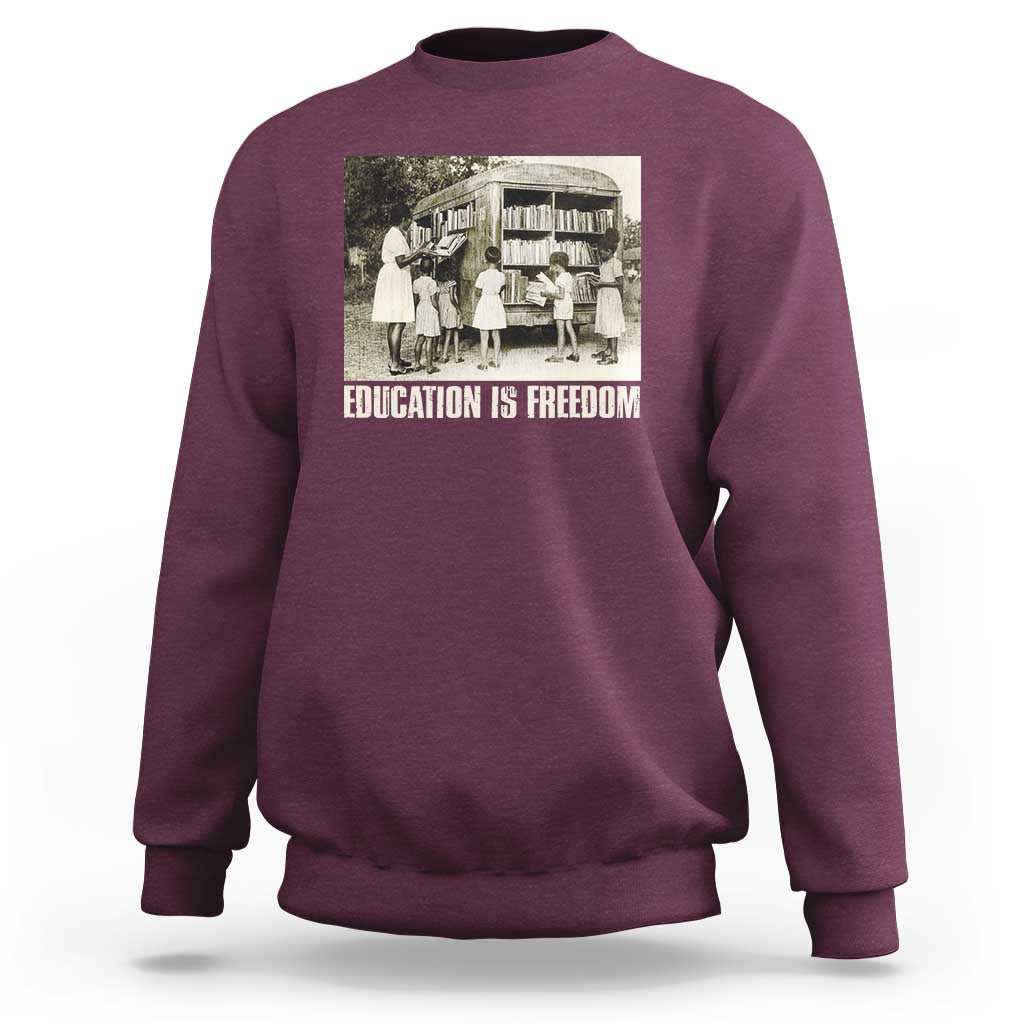 Maroon sweatshirt with 'EDUCATION IS FREEDOM' front graphic, crewneck long sleeves