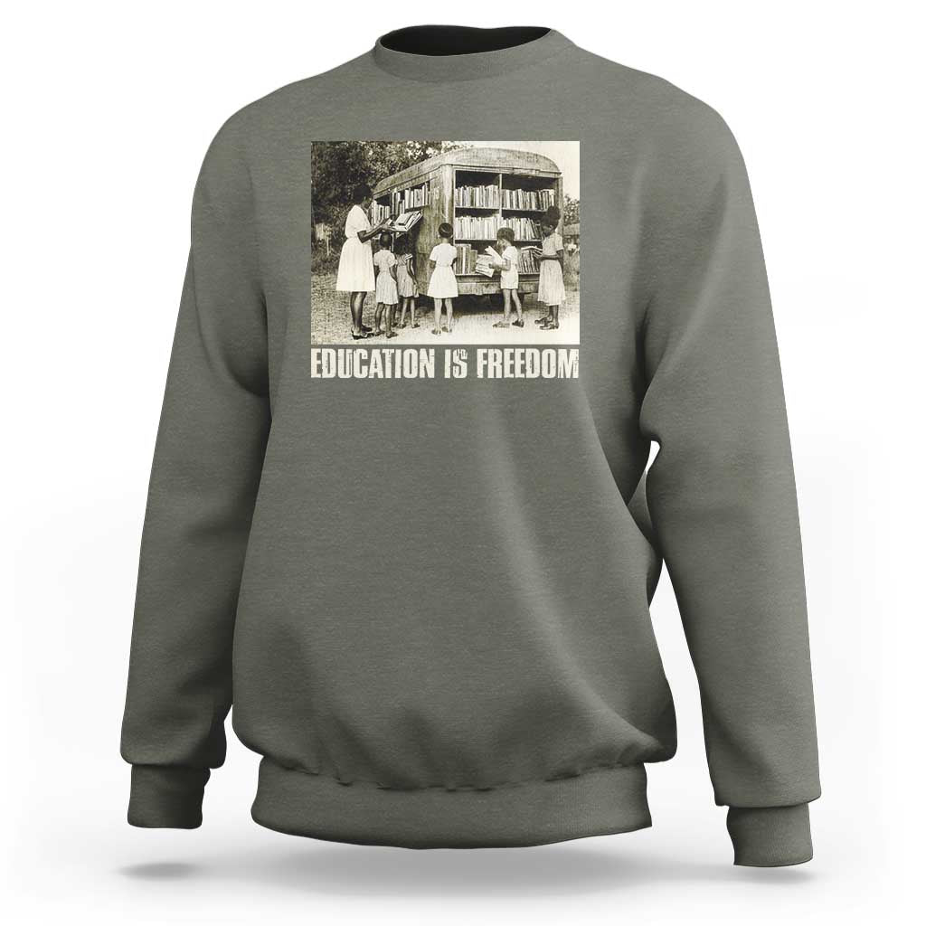 Gray sweatshirt with 'EDUCATION IS FREEDOM' front graphic, crewneck long sleeves