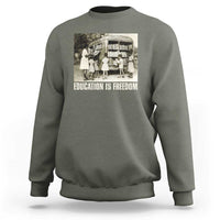 Gray sweatshirt with 'EDUCATION IS FREEDOM' front graphic, crewneck long sleeves