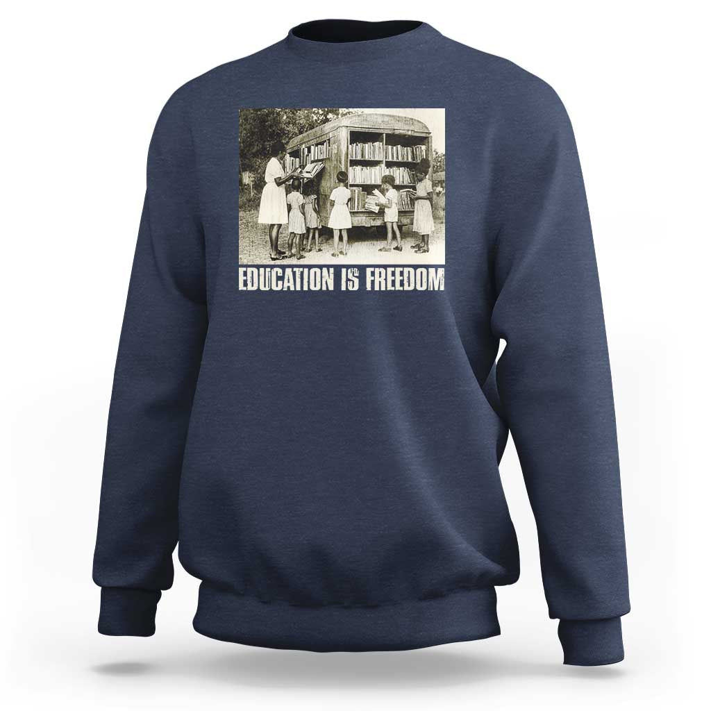 Navy sweatshirt with 'EDUCATION IS FREEDOM' front graphic, crewneck long sleeves