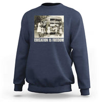 Navy sweatshirt with 'EDUCATION IS FREEDOM' front graphic, crewneck long sleeves