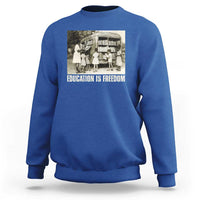Royal blue sweatshirt with 'EDUCATION IS FREEDOM' front graphic, crewneck long sleeves