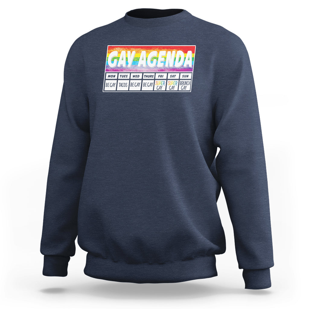 Navy crewneck sweatshirt with “GAY AGENDA” weekly schedule graphic on chest