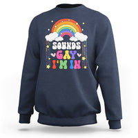 Medium blue crewneck sweatshirt with rainbow arch and colorful “Sounds Gay” print