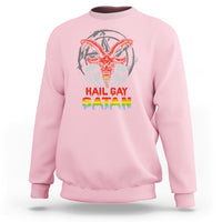 Light pink crewneck sweatshirt with skull and red/orange winged demon graphic