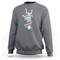 Charcoal gray sweatshirt with skeleton rock hand graphic and pride rainbow flag colors on back