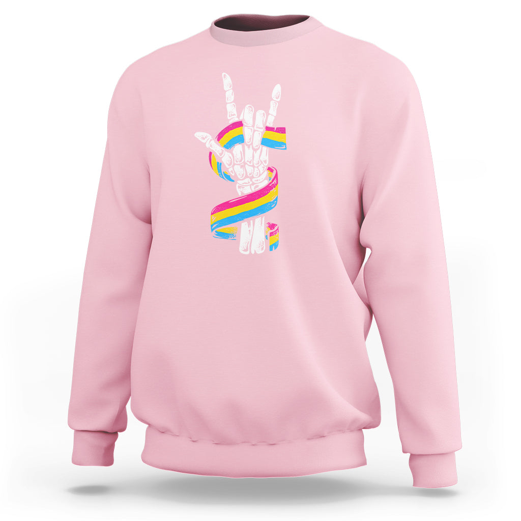 Light pink sweatshirt with skeleton rock hand graphic and pride rainbow flag colors on back