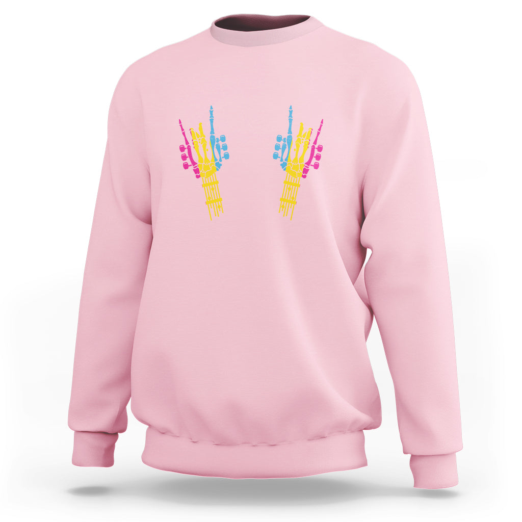 Light pink sweatshirt with colorful skeletal rock hand graphic on back