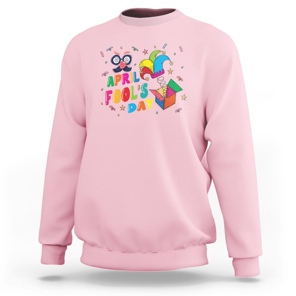 Light pink April Fool’s Day jester sweatshirt with colorful “April Fool’s Day” graphic