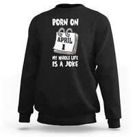 Black crewneck sweatshirt with "Born on April 1" joke text graphic on chest