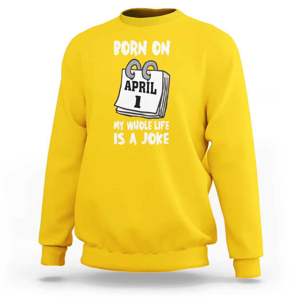 Daisy yellow crewneck sweatshirt with "Born on April 1" joke text graphic on chest