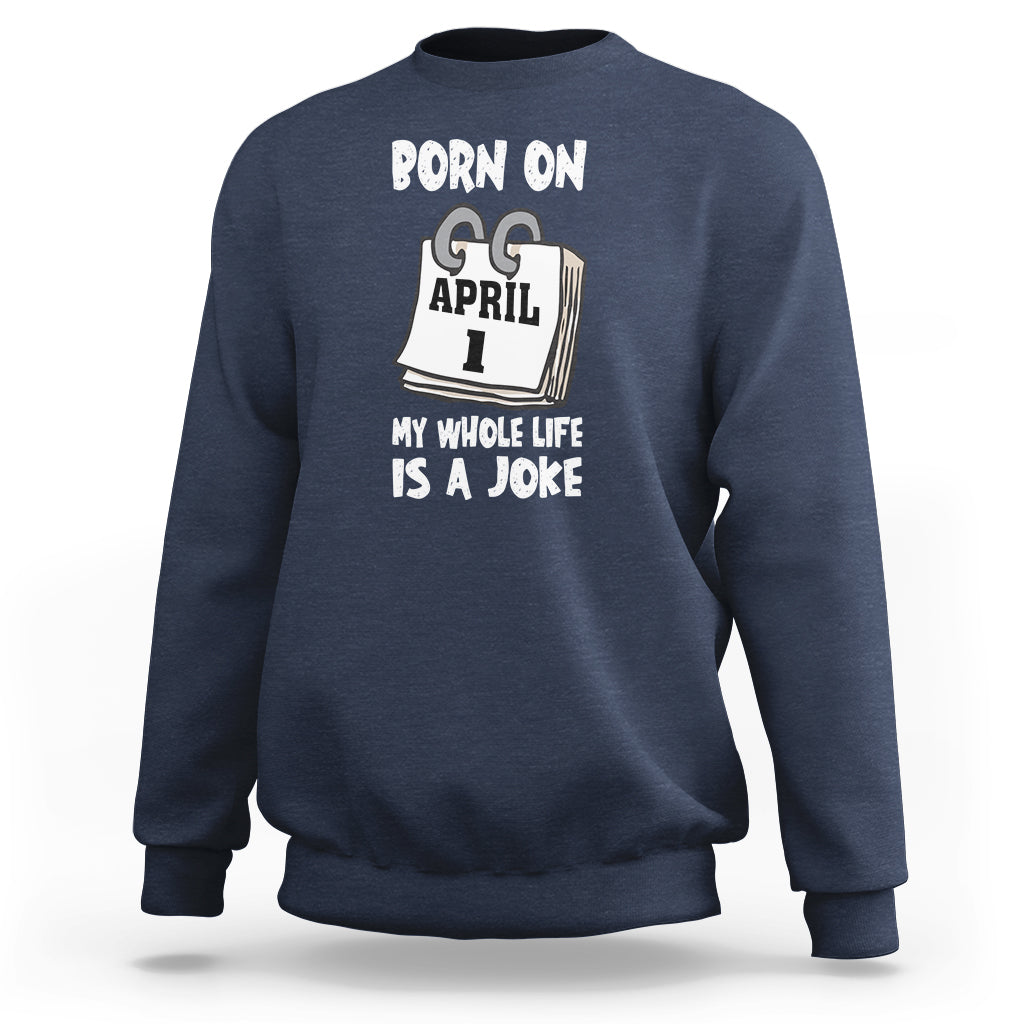 Navy crewneck sweatshirt with "Born on April 1" joke text graphic on chest