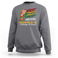 Gray sweatshirt with colorful Juneteenth graphic: raised fist, Believe Achieve Succeed