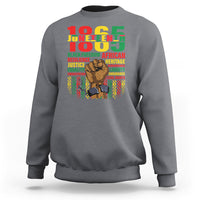 Charcoal Juneteenth sweatshirt with colorful 'Juneteenth' graphic and raised-fist portrait