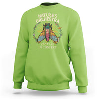 Lime green crewneck sweatshirt with cicada concert graphic and 'Nature's Orchestra' text.