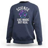 Dark navy sweatshirt with front graphic: “SCIENCE LIKE MAGIC BUT REAL” and atom icon