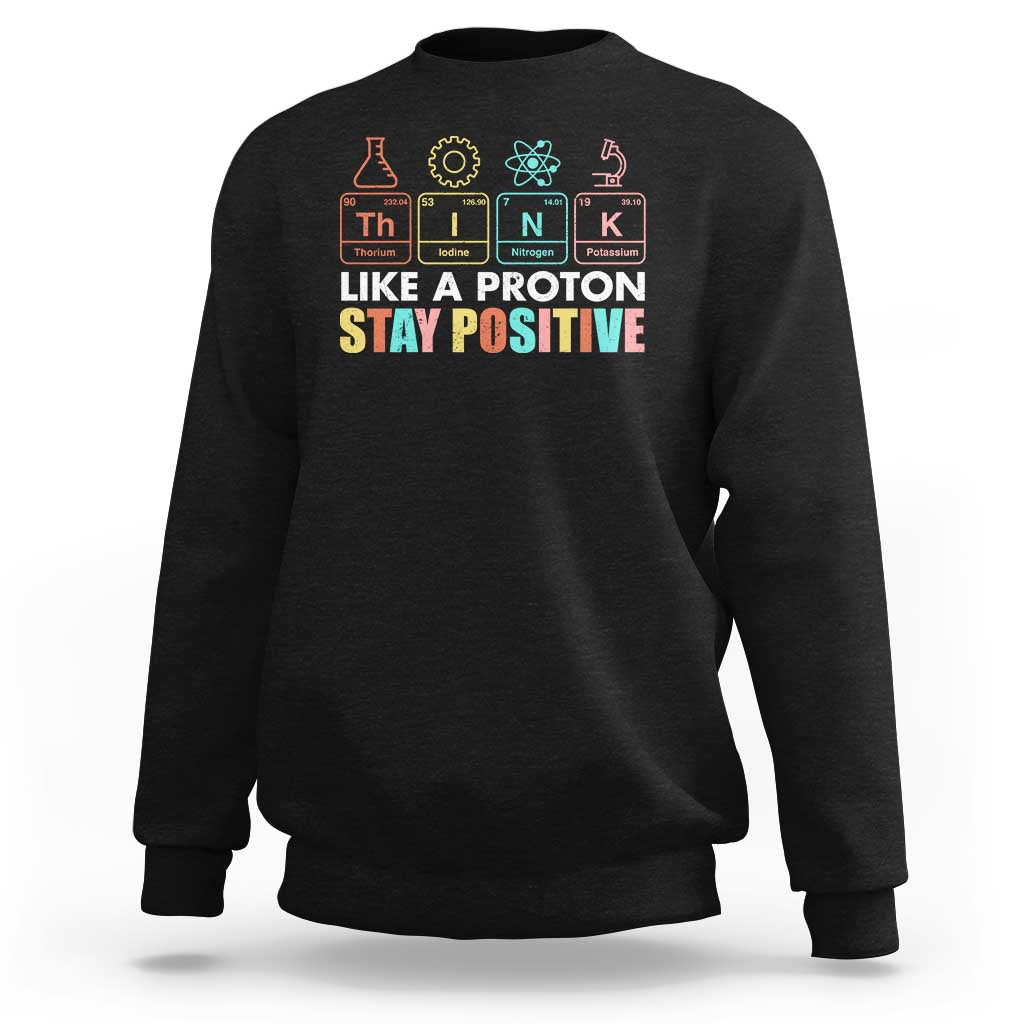 Black science sweatshirt with 'Like a Proton Stay Positive' chest graphic