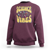 Maroon crewneck sweatshirt with “SCIENCE VIBES” science-themed graphic on chest