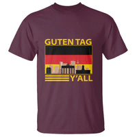 Maroon short-sleeve T-shirt with 'GUTEN TAG Y'ALL' German flag skyline graphic