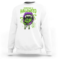 White Halloween sweatshirt with green HALLOWEED text and purple vampire plant graphic