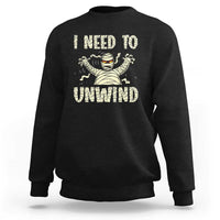 Black Halloween mummy sweatshirt with 'I need to unwind' graphic on chest