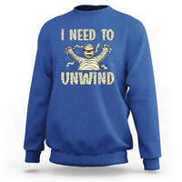 Royal blue Halloween mummy sweatshirt with 'I need to unwind' graphic on chest