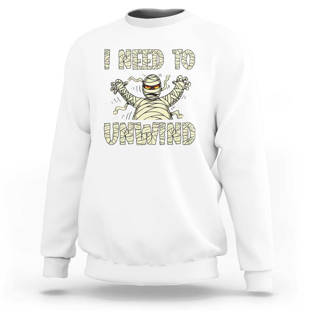 White Halloween mummy sweatshirt with 'I need to unwind' graphic on chest