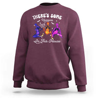 Maroon Halloween sweatshirt with glowing horror house graphic on the front