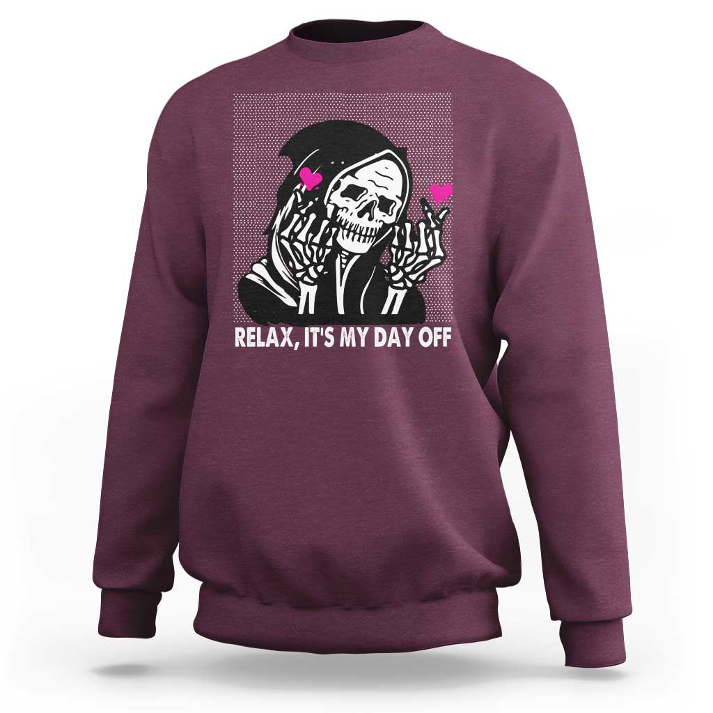 Maroon crewneck sweatshirt with grim reaper graphic and “Relax, It’s My Day Off” text