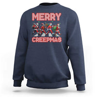 Navy crewneck sweatshirt with “MERRY” and “CREEPMAS” graphic and horror characters