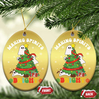 Gold oval Christmas ornaments with ghost and Christmas tree graphic, hanging loops