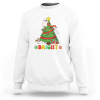 White crewneck sweatshirt with cute ghost Christmas tree graphic and “Bright” text.
