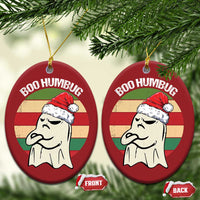 Red round “BOO HUMBUG” ghost ornaments hanging on gold strings