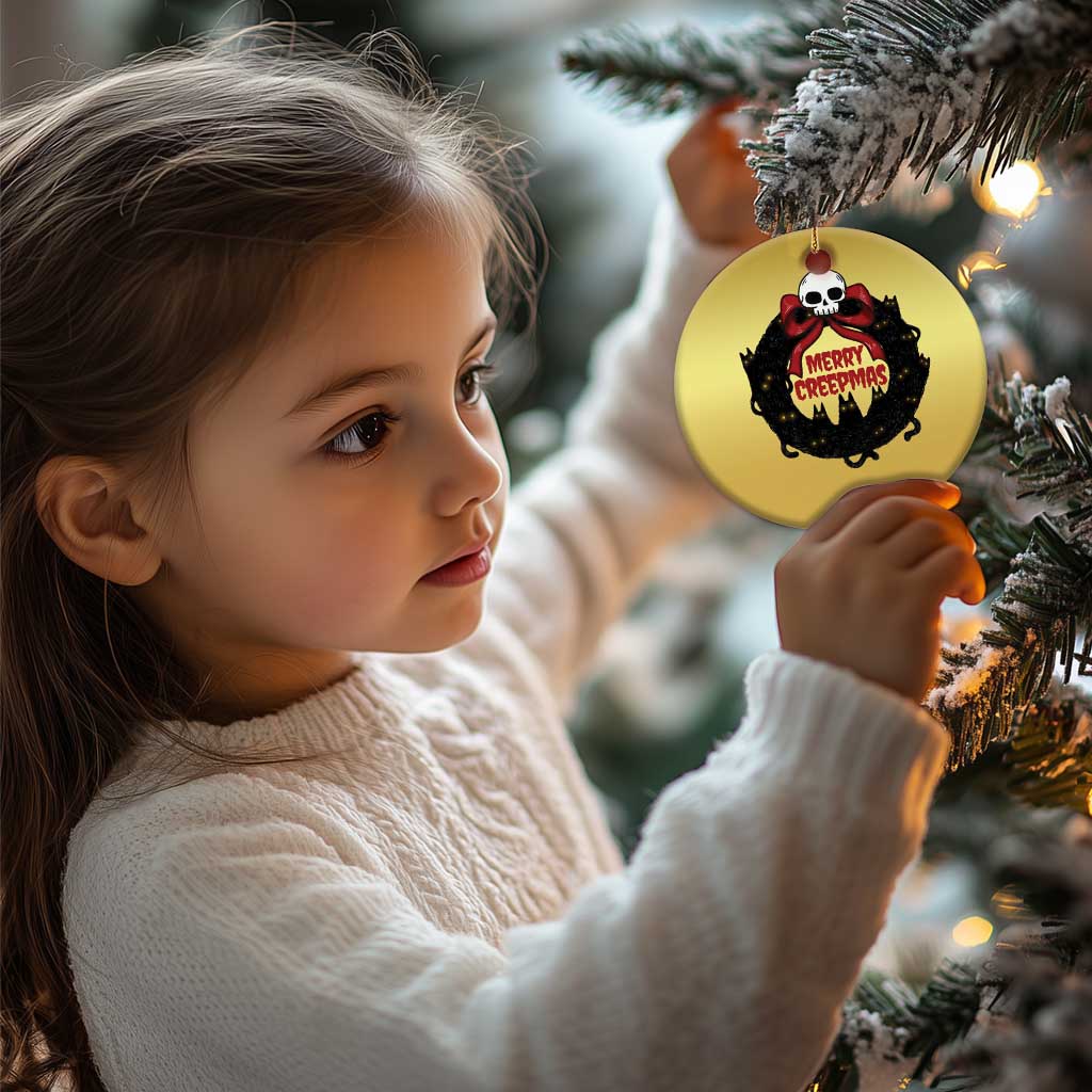 Gold round cat-wreath ornament with skull and “Merry Creepmass” text near a child