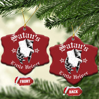 Two red heart-shaped Satan's Little Helper ornaments on a tree; front and back labels