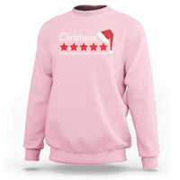 Light pink Christmas sweatshirt with white Santa hat graphic and star text on chest