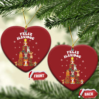 Two red heart-shaped Feliz Navidog dog Christmas ornaments with gold loops, front and back