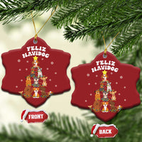 Two red heart-shaped Feliz Navidog dog Christmas ornaments with gold loops, front and back