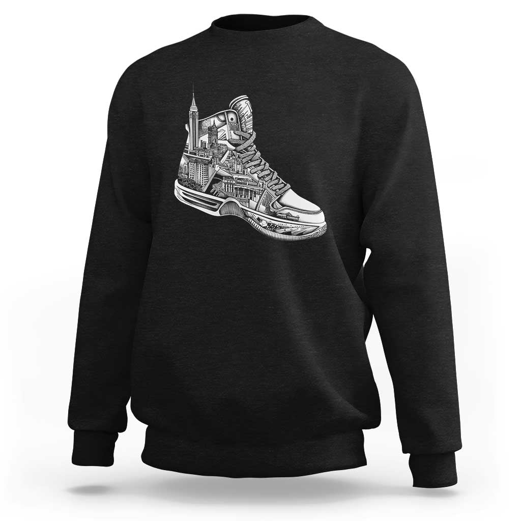 Black crewneck sweatshirt with white sneaker graphic on the chest