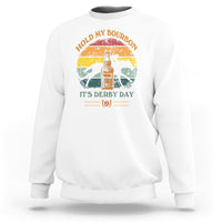White sweatshirt with horse-and-bourbon graphic and “It’s Derby Day” text on front.