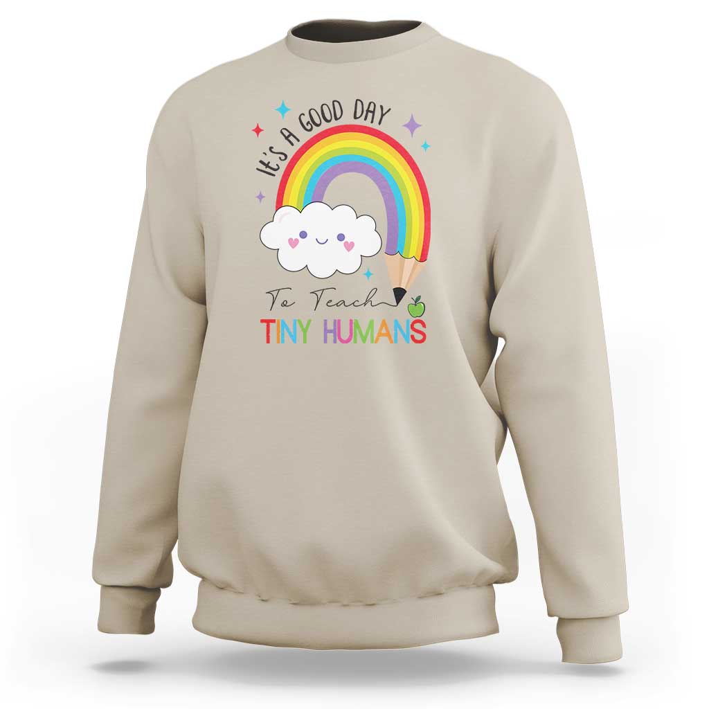 Pre-school teacher sweatshirt in sand with rainbow and “Tiny Humans” graphic
