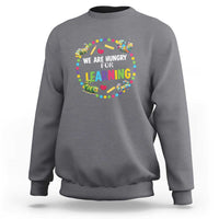 Charcoal gray pre-school teacher sweatshirt with colorful “We Are Hungry for Learning”