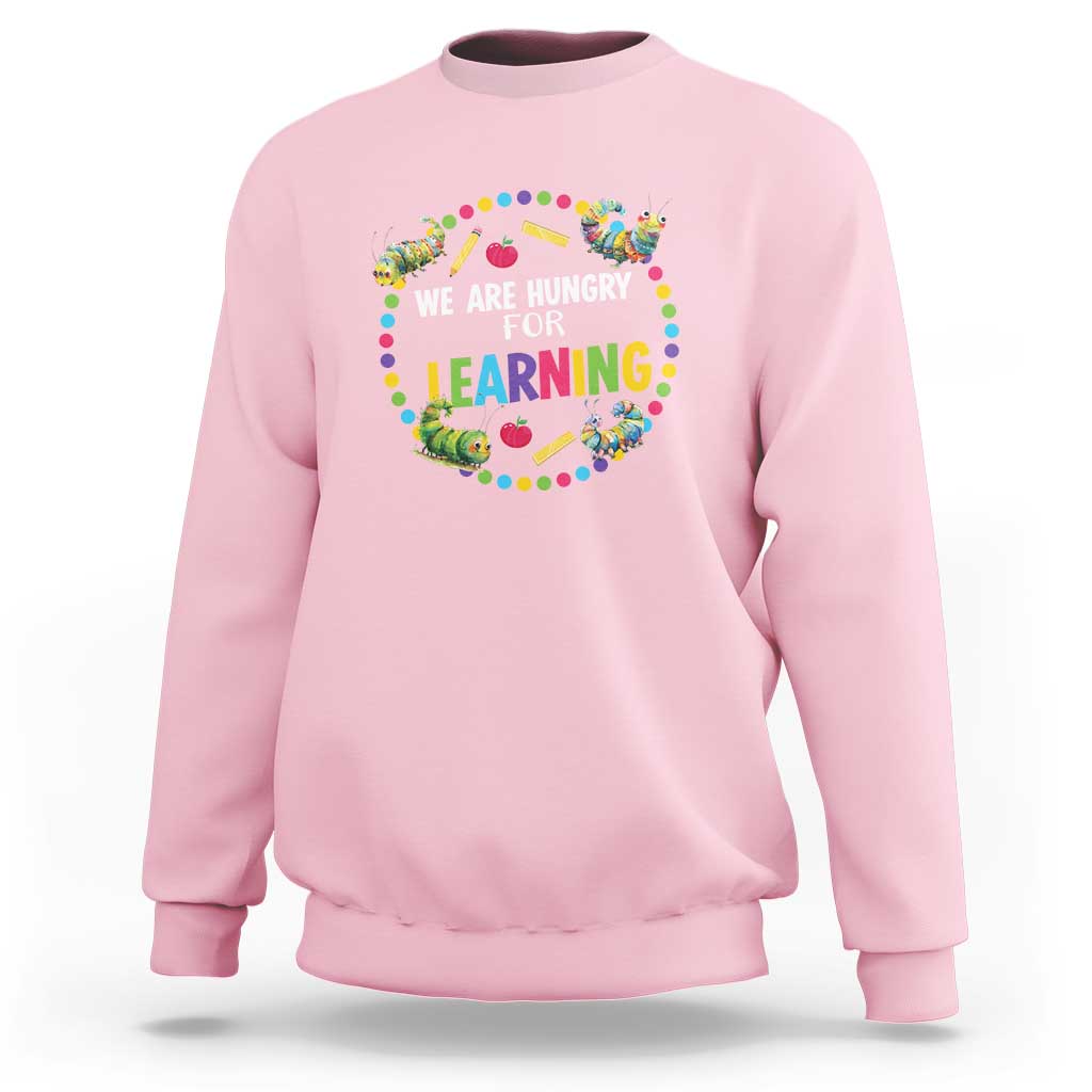 Light pink pre-school teacher sweatshirt with colorful “We Are Hungry for Learning”