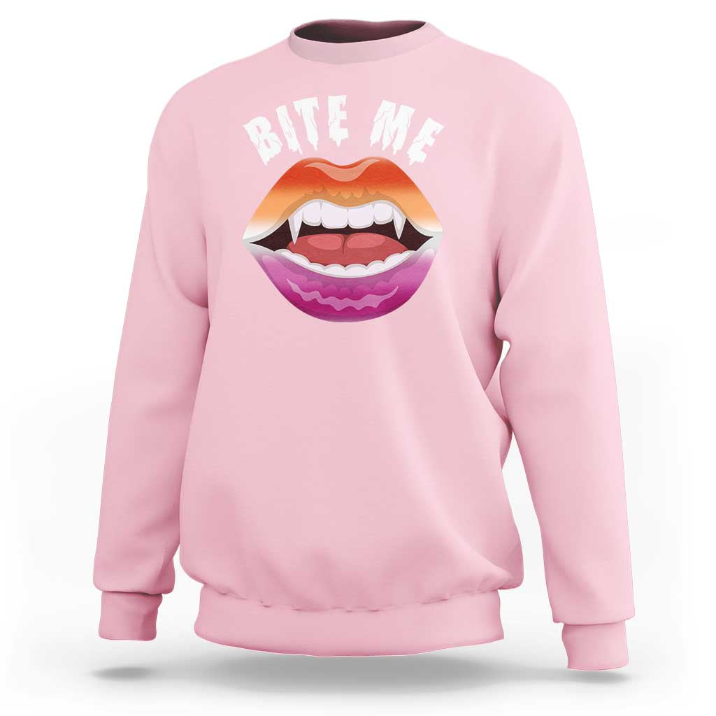 Light pink crewneck sweatshirt with 'BITE ME' text and colorful mouth graphic on chest