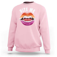 Light pink crewneck sweatshirt with 'BITE ME' text and colorful mouth graphic on chest