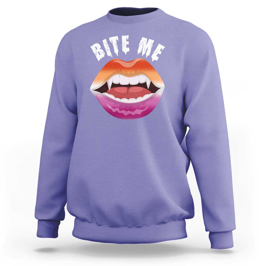 Lavender crewneck sweatshirt with 'BITE ME' text and colorful mouth graphic on chest